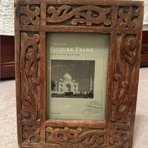 World Market wooden tabletop picture frame holds 5 x 7 pictures. Made in India